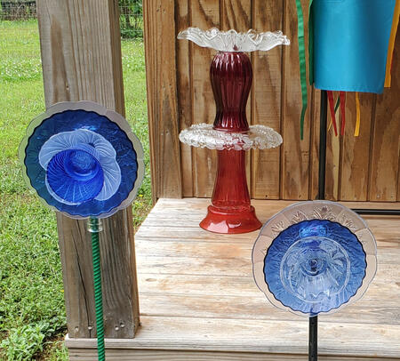 Glass Flower Art Pieces made from repurposed glass. *All of our garden art and repurposed glass pieces are made with industrial all weather adhesive. *To protect the gl